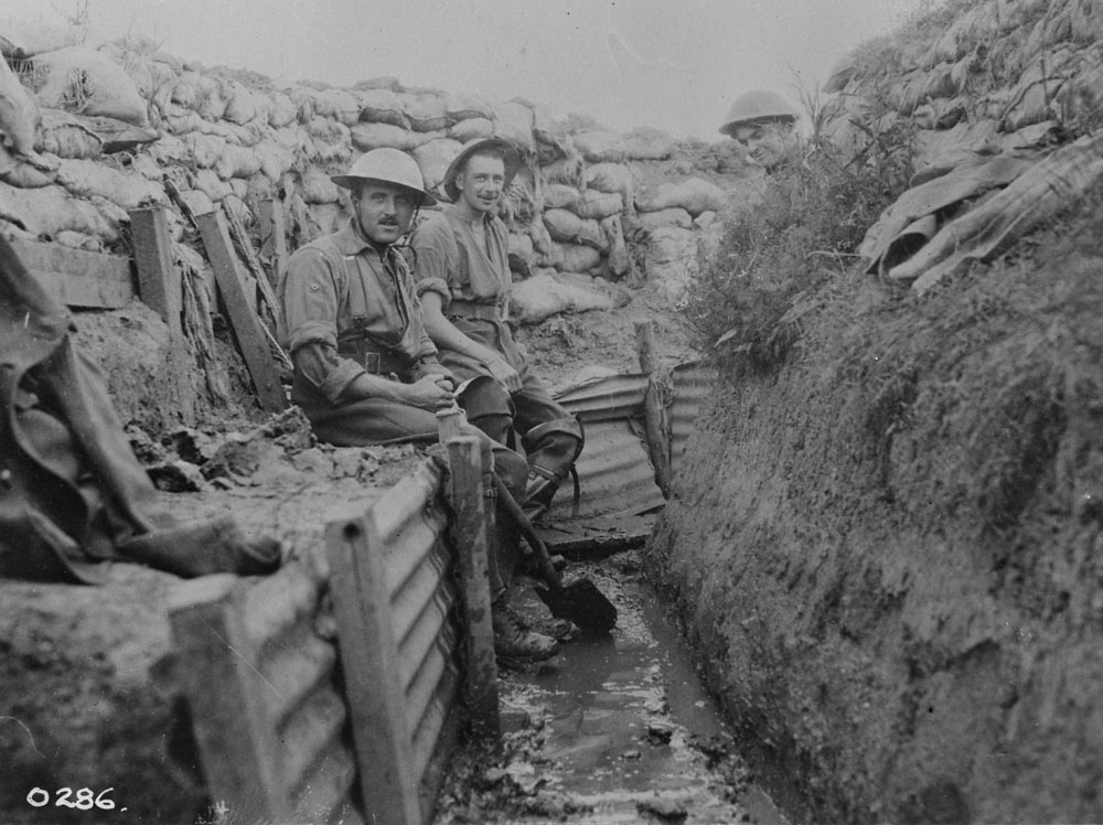 Draining Trenches. 22nd Infantry Battalion (French Canadian). [A researcher has provided information identifing the man on the left as Sapper William Henry Snow of the Canadian Engineers.]