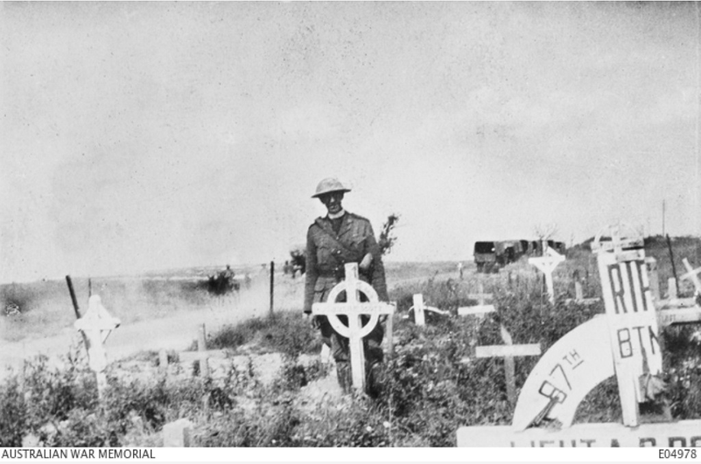 E04978 Canadian_Senior_Chaplain_Canon_Frederick_George_Scott_stands_by_the_grave_of_his